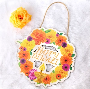 Detail of wooden Diwali welcome sign with marigold flowers and Happy Diwali lettering