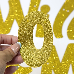 Detailed close-up of golden glitter number zero banner for retirement party decorations