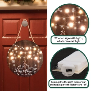 Detail of wooden Merry Christmas door sign with LED lights and battery switch box