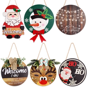 Detail view of six wooden Christmas door signs with Santa, reindeer and jute rope hangers