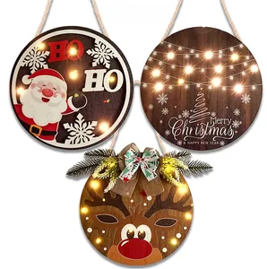 Close-up of three wooden Christmas LED ornaments with Santa, tree, and reindeer patterns