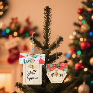 Christmas wood hanging signs with festive bows and bells displayed on pine branches