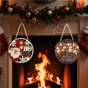 Detail of round wooden Christmas door hangers with LED lights and festive deer snowflake designs