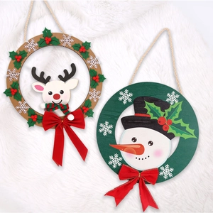 Detail of Christmas wooden ring ornaments with reindeer, snowman and red bows