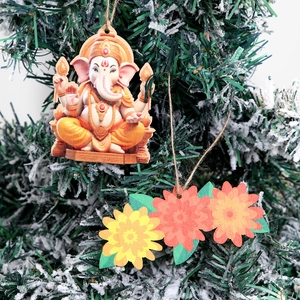 Diwali Ganesha and floral wood pendants on a tree for Indian festival party decor