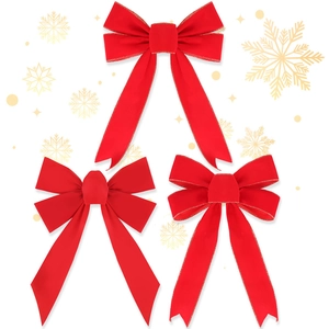 Close-up of red velvet Christmas bows with gold wire edges and neat swallowtail ribbons