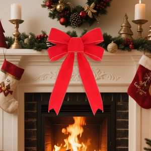 Detail of red velvet Christmas bow with gold stitched edges on a festive fireplace