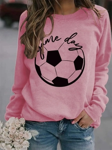 Detail of pink crewneck sweatshirt featuring black Game Day text and football print