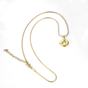Detail of a gold-plated snake chain with a 3D letter D pendant and adjustable lobster clasp