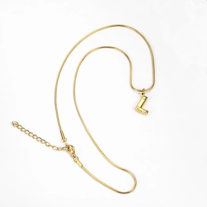 Detailed shot of golden snake chain with letter L bamboo style pendant and lobster clasp