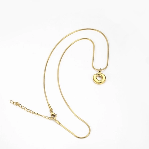 Macro detail of gold snake chain with round O-shaped pendant and lobster clasp