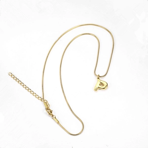 Detail of golden letter P pendant with sleek snake chain and lobster clasp closure