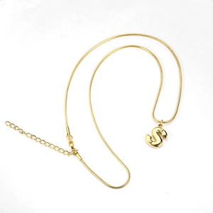 Detail of a gold snake chain necklace with a 3D letter S pendant and lobster clasp