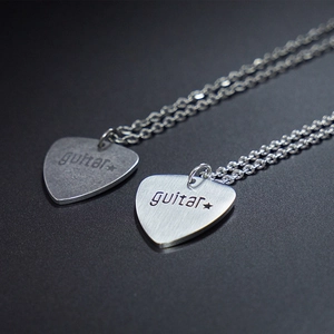 Vintage stainless steel guitar pick necklaces with engraved stars and guitar text detail