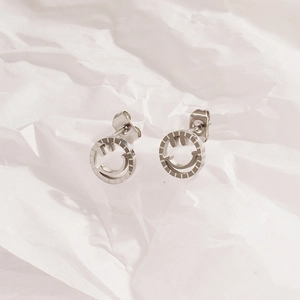 Boucles d'oreilles minimalistes smiley argenté plaqué or 18 carats sur fond blanc