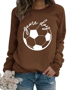 Detail of Game Day print on a brown crewneck sweatshirt paired with blue denim jeans