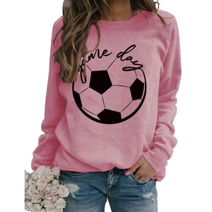 Detail of pink crewneck sweatshirt featuring a black football and Game Day printed text