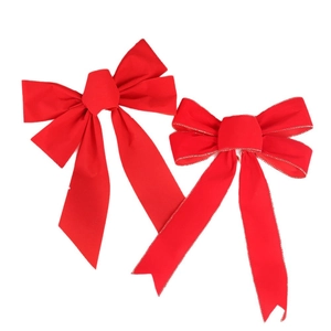 Pair of red velvet Christmas bows with gold trim and long ribbons for festive decor