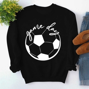 Flat lay of black Game Day crewneck sweatshirt with football graphic and styling accessories