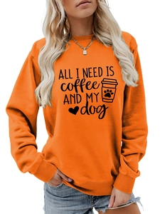 Detail of ribbed cuffs and All I Need Is Coffee and My Dog print on orange sweatshirt
