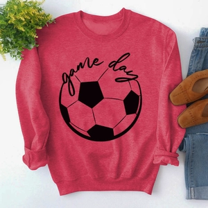 Detailed view of red GAME DAY sweatshirt with ribbed cuffs and hem on flat lay