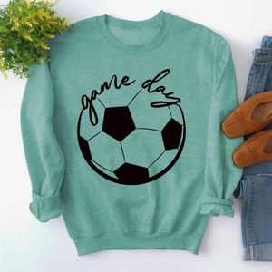 Close-up of mint green crewneck sweatshirt with black GAME DAY football print layout