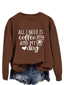 Close-up of All I Need is Coffee and My Dog print on brown loose crewneck sweatshirt