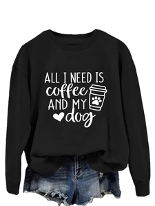 Detail of ALL I NEED IS COFFEE AND MY DOG print on a black long sleeve sweatshirt