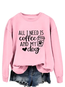 Pink crewneck sweatshirt detail featuring black text print and heart paw graphic