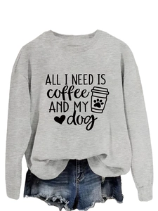 Detail of grey crewneck sweatshirt featuring All I Need Is Coffee and My Dog print design