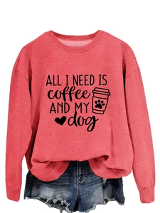 Detail of pink crewneck sweatshirt featuring All I Need Is Coffee and My Dog print