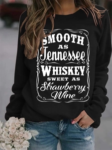 Detail of black crewneck sweatshirt featuring white vintage-style Tennessee Whiskey print