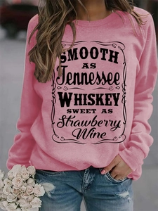 Close-up of Smooth as Tennessee Whiskey typography print on pink cotton crewneck sweatshirt