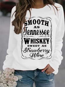 Detail of white crewneck sweatshirt with Tennessee Whiskey text print in street style