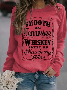 Detail of red crewneck sweatshirt featuring Tennessee Whiskey typography print
