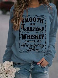Detail of Smooth as Tennessee Whiskey typography on a blue crewneck sweatshirt