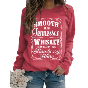 Detail of red crewneck sweatshirt featuring white vintage lyrics graphic print