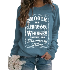 Detail view of smooth as Tennessee whiskey letter print on blue crewneck sweatshirt