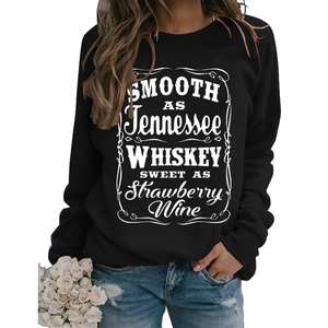 Close-up of typography print on black crewneck sweatshirt with vintage artistic lettering