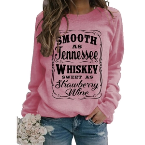 Close-up of pink sweatshirt featuring Smooth as Tennessee Whiskey letter printing