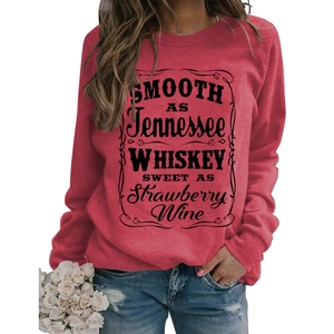 Detail view of a red crewneck sweatshirt with vintage black whiskey-themed typography