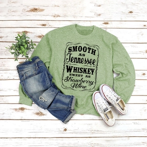 Flat lay of sage green sweatshirt with Tennessee lyrics, jeans and white sneakers