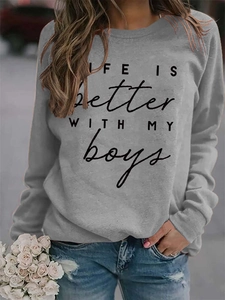 Detail of the Life Is Better slogan print on a casual grey crewneck sweatshirt