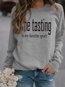 Detail of the humoristic wine tasting slogan print on a grey crewneck sweatshirt