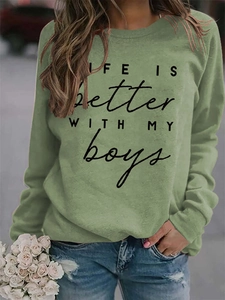 Detail of LIFE IS BETTER print on olive green crewneck sweatshirt with modern typography