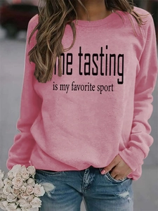 Close-up of the Wine Tasting print on a pink crewneck sweatshirt with a cozy soft texture