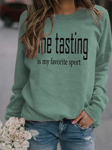 Detail of sage green sweatshirt featuring wine tasting print and casual crew neck fit