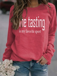 Detail of red crew neck sweatshirt featuring 'Wine tasting is my favorite sport' white text
