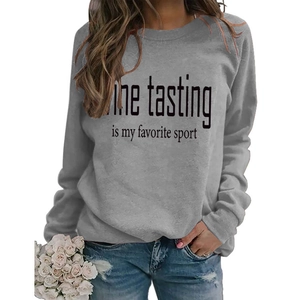 Detail of the tasting is my favorite sport print on a dark gray crewneck sweatshirt