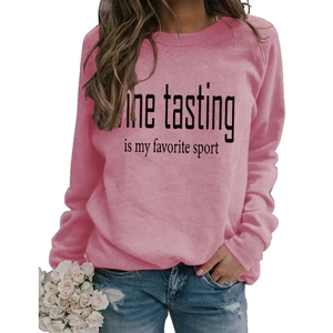 Pink crew neck sweatshirt with 'Wine tasting' graphic paired with denim jeans